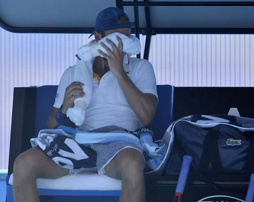 United States' Denis Kudla uses a cool towel during a break while playing Austria's Dominic Thiem during their second round match yesterday. (AAP)