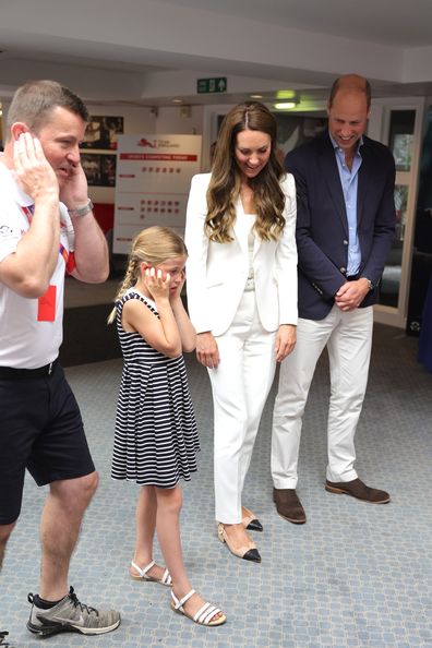 Tim Lawler CEO of SportsAid, Princess Charlotte of Cambridge, Catherine, Duchess of Cambridge and Prince William, Duke of Cambridge watch a demonstration of a bicycle powered smoothie maker during a visit to SportsAid House at the 2022 Commonwealth Games on August 02, 2022 in Birmingham, England. 