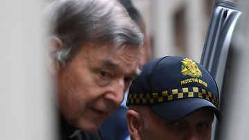 George Pell is led into the back of a police van after his unsuccessful appeal. 
