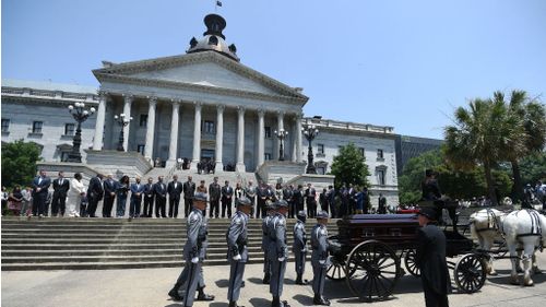 Senator Clementa Pinckney's body arrives by horse drawn carriage at the South Carolina Statehouse. (AAP)