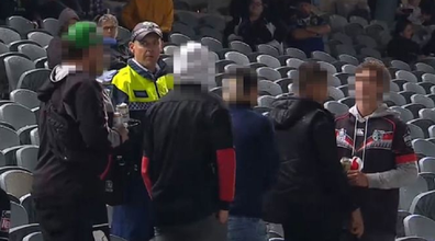 Police speak with the fans accused of making the racist comments.