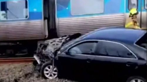 Vision of a car on the Melbourne train trucks being hit by a train