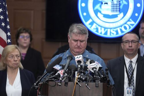 Maine State Police Col. William Ross, center, appears emotional as he faces reporters while Maine Gov. Janet Mills, left, and Maine Commissioner of Public Safety Mike Sauschuck, right, look on, Thursday, Oct. 26, 2023, during a news conference at Lewiston City Hall, in Lewiston, Maine.