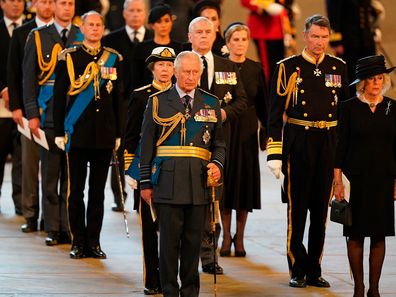 Prince Andrew stood alone while his family members stood in pairs surrounding him.