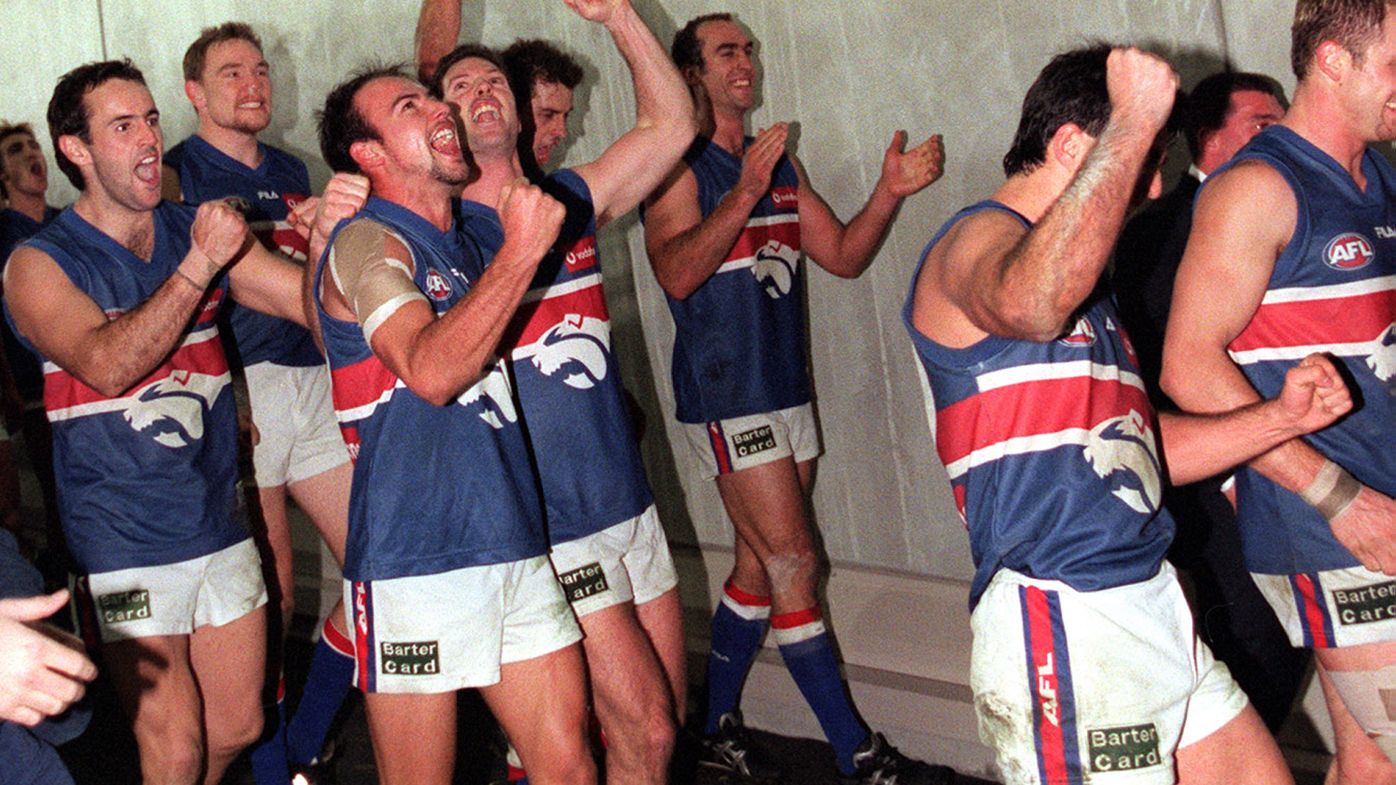 Western Bulldogs players celebrate their upset win after they defeated Essendon by 11 points in round 21 of the 2000 AFL season.