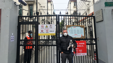 Michael Smith (and his dog Huey) outside his compound in Shanghai. 