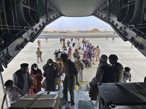 In this photo provided by the Spanish Defence Ministry and taken in Kabul, Afghanistan, people board a Spanish airforce A400 plane as part of an evacuation plan at Kabul airport in Afghanistan.