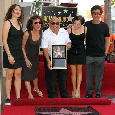 Rhea Pearlman and actor Danny DeVito and their family pose for photographers during the installation ceremony for actor Danny DeVito's star on the Hollywood Walk of Fame on August 18, 2011.