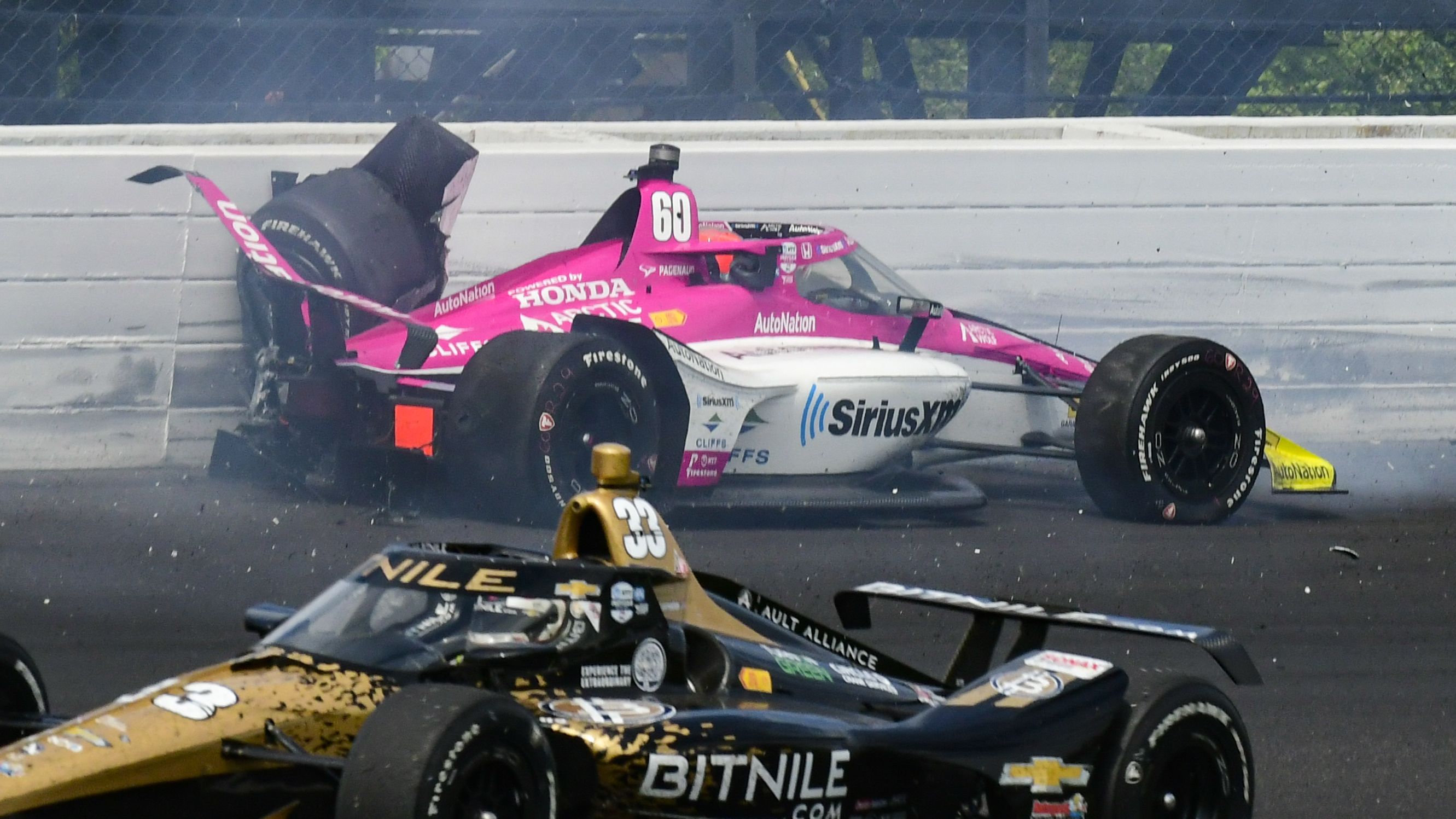 Simon Pagenaud hits the wall in the third turn during the Indianapolis 500 after contact with Scott McLaughlin.
