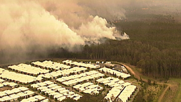 9News was told the fire has burnt right up to gardens in some homes at Lakes Innes and Lake Cathie.