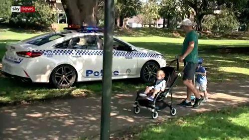 Police speak to a father and two young kids at Ruschutters Bay park.