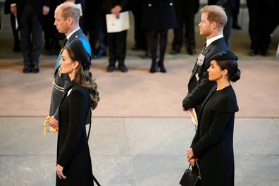 Catherine, Princess of Wales, Prince William, Prince of Wales, Meghan, Duchess of Sussex and Prince Harry, Duke of Sussex pay their respects in The Palace of Westminster after the procession for the Lying-in State of Queen Elizabeth II on September 14, 2022 in London, England. 