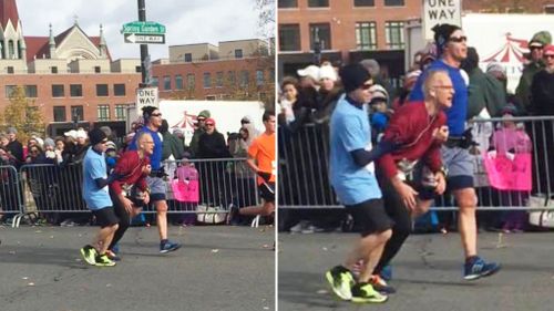 Marathon runners stop to help struggling man cross finish line