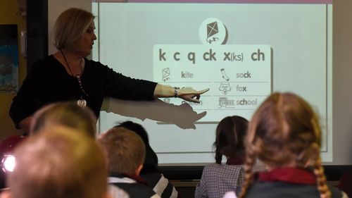 A teacher points at a board during a lesson at Stafford State School in Brisbane, Wednesday, Aug. 5, 2015. 