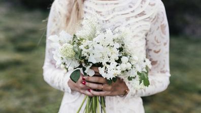 Bride with wedding dress and flowers