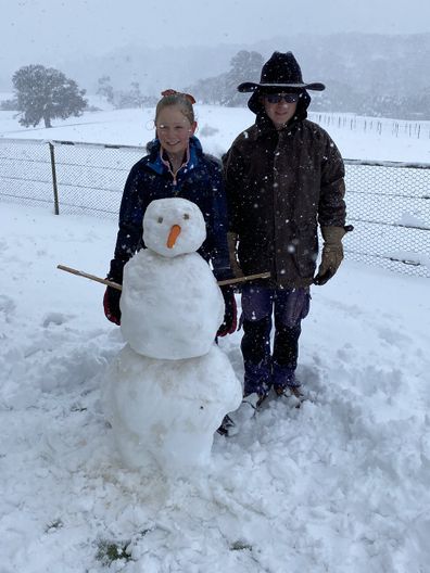 Lydia and Callum build a snowman