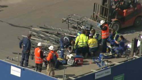 Workers helping the man at the scene. 