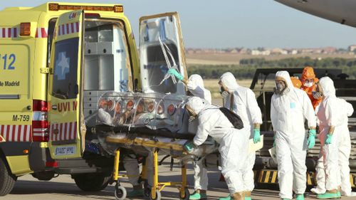 First Ebola victim arrives in Europe, as reports emerge of bodies dumped in streets