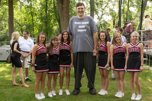 Igor Vovkovinskiy towers above a group of cheerleaders from the Cannon Falls High School in Cannon Falls, Minnesota.