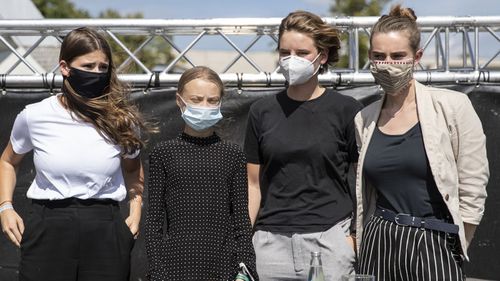  German climate activist Luisa Neubauer (L-R), Swedish climate activist Greta Thunberg, Belgian climate activist Anuna De Wever and Belgian climate activist Adelaide Charlier pose for a group picture after a press conference following the meeting with German Chancellor Angela Merkel on August 20, 2020 in Berlin, Germany