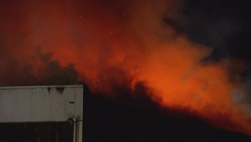 Two female firefighters are in hospital, with one critical, after a blaze engulfed a warehouse south of Brisbane.
