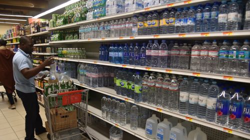 A worker restocks shelves in Haiti, after residents flocked to stock up on supplies ahead of the storm. (AFP)