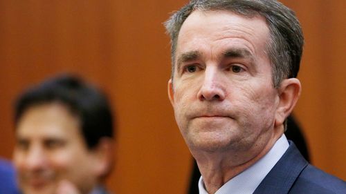 Virginia Governor Ralph Northam has told a source he now believes it is not him in a racist yearbook photo and will not resign despite mounting pressure.