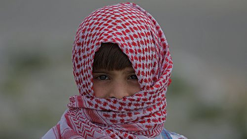 A Palestinian refugee boy attends a protest commemorating Land Day along the border between Israel and Gaza Strip. (EPA)