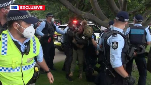 ACT Police said two men were arrested for interfering with the arrest of a woman, who allegedly assaulted officers.