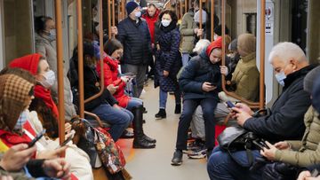 People ride a subway carriage as some of them read on their smartphones  in Moscow, Russia, Thursday, Feb. 24, 2022. (AP Photo/Alexander Zemlianichenko Jr)