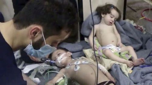 Young children treated in aftermath of suspected chemical attack. (AAP)
