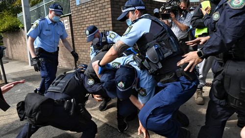 Police arrest protestors at Victoria Park in Sydney.