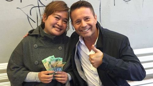 Grand! Stevie Jacobs poses with the woman, who finally accepted the cash. (TODAY)