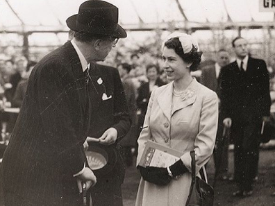 Queen Elizabeth speaks with officials during one of her first appearances at the Chelsea Flower Show.