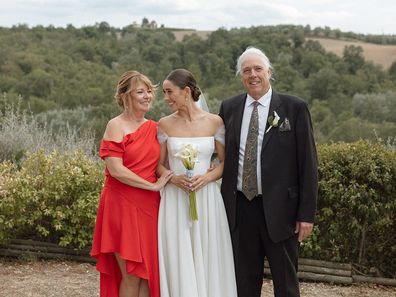 Scout Shmygol on her wedding day with her parents.