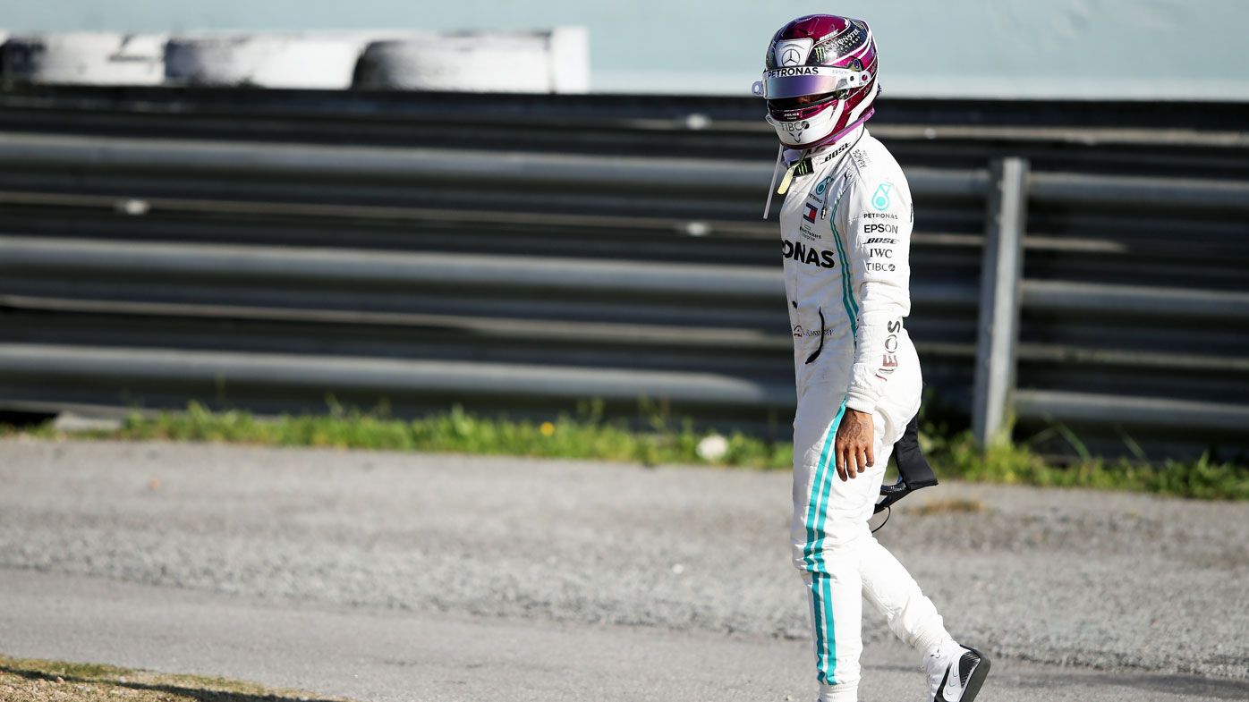 Lewis Hamilton of Great Britain and Mercedes GP walks on a circuit road after his car stopped on track during Day Two of F1 Winter Testing