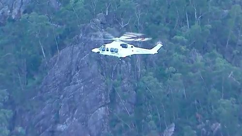 A rescue mission is under way for a man who fell down a mountain in Queensland. 