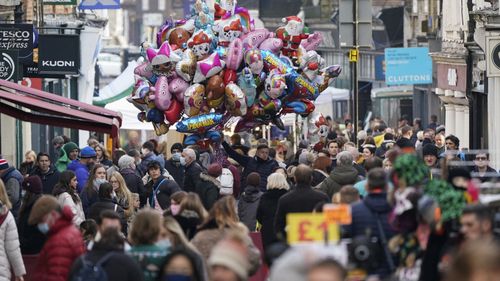 Christmas shoppers make their way along the High Street in Winchester, England as the government refused to rule out introducing further restrictions to slow the spread of the Omicron variant.