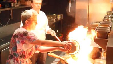 Chef David Thompson shows food writer Jane de Graaff how to stir-fry