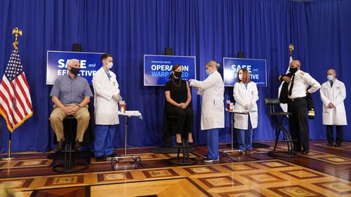 Karen Pence, seated center, receives a Pfizer-BioNTech COVID-19 vaccine shot at the Eisenhower Executive Office Building on the White House complex, Friday, Dec. 18, 2020, in Washington