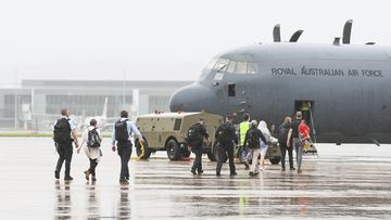 Australian Federal Police personnel are seen boarding a RAAF C-130 Hercules  bound for the Solomon Islands.