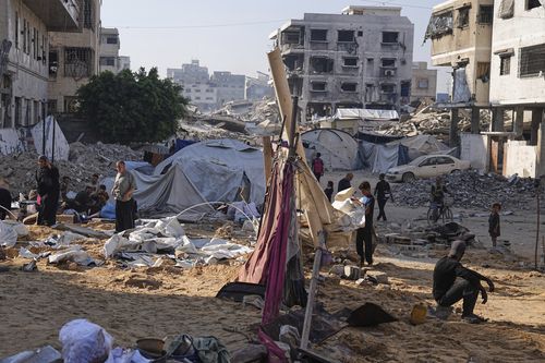 Palestinians inspect damaged tents after an Israeli strike hit a displacement camp in Gaza City, Saturday, June 28, 2025. (AP Photo/Jehad Alshrafi)