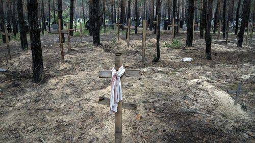 A view shows unidentified graves of civilians and Ukrainian soldiers in a cemetery, in the recently retaken area of Izium, Ukraine, Friday, Sept. 16, 2022. 