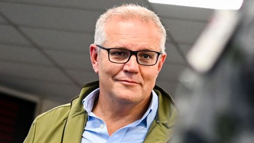 Prime Minister Scott Morrison speaks to members of the Australian Defence Force after an aerial tour of flood affected areas.