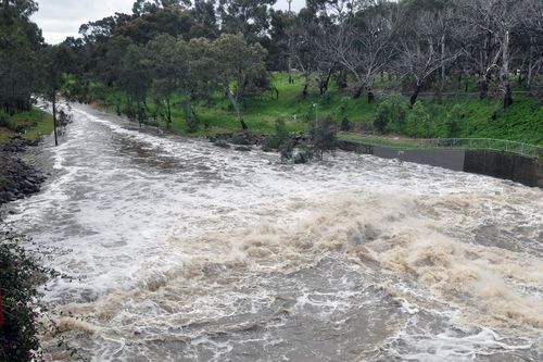 Floodwater surge down the River Torrens in Adelaide after the wild storms that contributed to the state's blackout. (AAP)