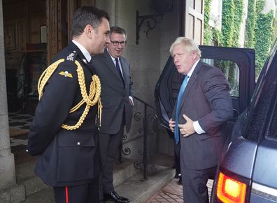 Outgoing Prime Minister Boris Johnson is greeted by the Queen Elizabeth II's Equerry Lieutenant Colonel Tom White and her private Secretary Sir Edward Young as he arrives for an audience to formally resign as Prime Minister at Balmoral Castle on September 6, 2022 in Aberdeen, Scotland.  