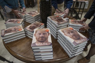 Members of staff place the copies of the new book by Prince Harry called "Spare" at a book store in London, Tuesday, Jan. 10, 2023. 