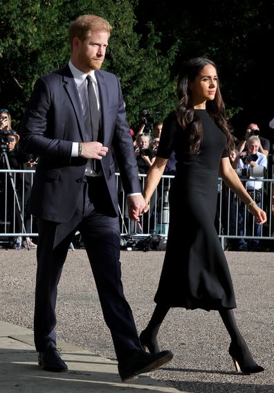 Prince Harry, Duke of Sussex, and Meghan, Duchess of Sussex on the long Walk at Windsor Castle arrive to view flowers and tributes to HM Queen Elizabeth on September 10, 2022 in Windsor, England.  