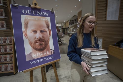 A member of staff places the copies of the new book by Prince Harry called "Spare" at a book store in London, Tuesday, Jan. 10, 2023.  