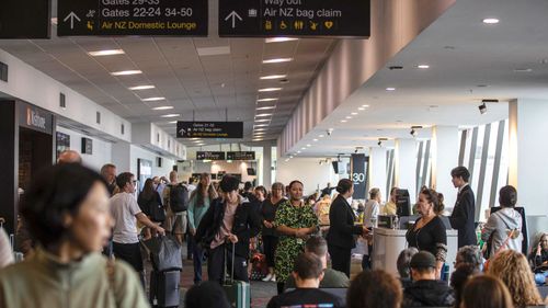 Passengers wait for a flight in Auckland Airport.